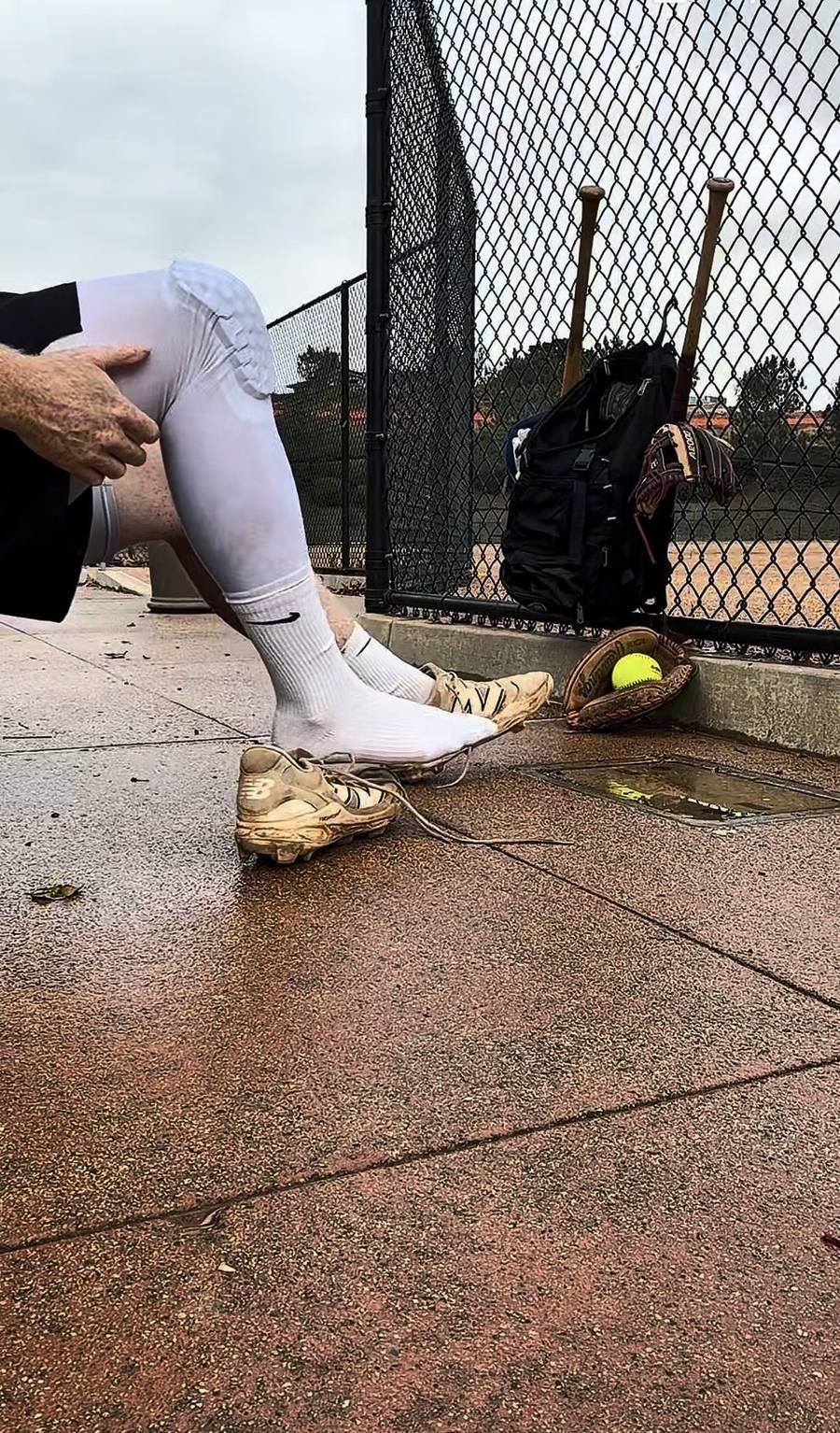 Daniel in the dugout on a wet morning with his gear